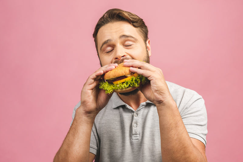 Mann beißt in einen Hamburger