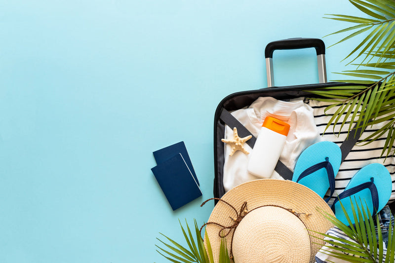 Sommerurlaub-Essentials: offener Koffer sommerlich gepackt