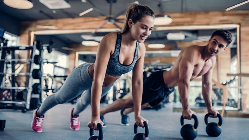 Kaloriendefizit berechnen: Mann und Frau machen zusammen Fitness-Übungen