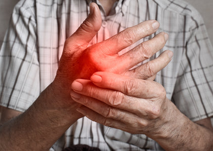 Mann greift sich an die schmerzende Hand