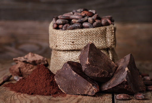 Stücke von dunkler Schokolade und Kakaobohnen